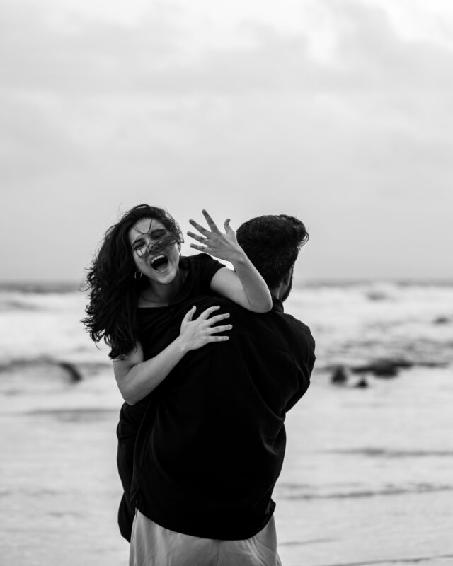 Woman showing her ring while embracing her partner