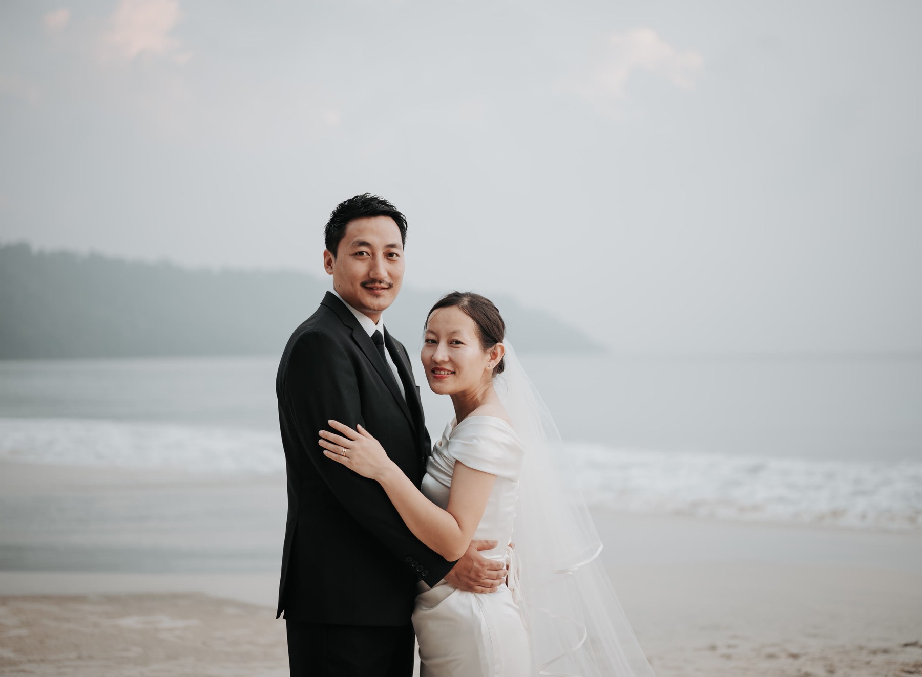 Wedding couple embracing on an island beach
