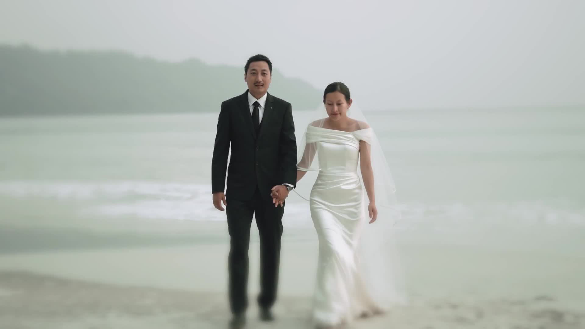 White gown couple on the beach with a flowing veil